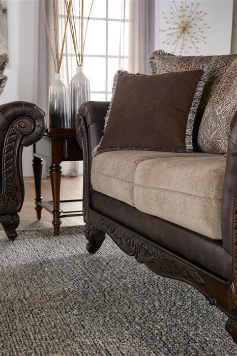 Elmbrook - Upholstered Rolled Arm Loveseat With Intricate Wood Carvings - Brown